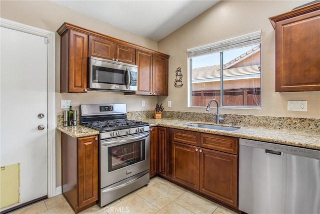 7471 Windrose Dr, Highland, CA 92346 - kitchen featuring stainless steel appliances, light tile patterned floors, and light stone countertops