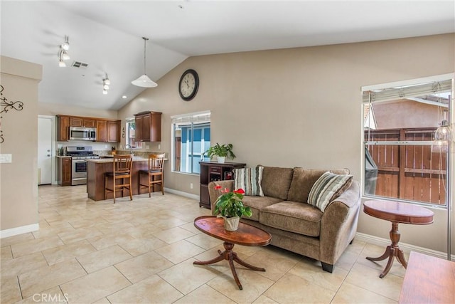 7471 Windrose Dr, Highland, CA 92346 - living room featuring vaulted ceiling and plenty of natural light