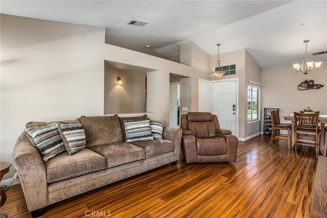 7471 Windrose Dr, Highland, CA 92346 - living area featuring a chandelier, dark wood-style flooring, and vaulted ceiling