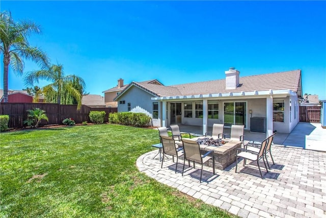 7471 Windrose Dr, Highland, CA 92346 - rear view of house featuring a chimney, a fenced backyard, a tiled roof, a fire pit, and a patio area