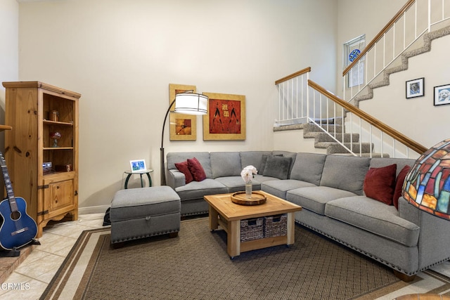 6613 Sargent Ln Unit 86, Ventura, CA 93003 - living room featuring a towering ceiling, stairway, and tile patterned flooring