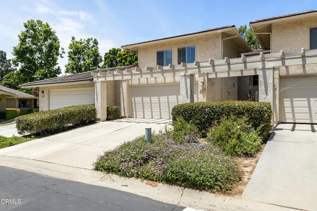 6613 Sargent Ln Unit 86, Ventura, CA 93003 - view of front of house with stucco siding, concrete driveway, and a garage