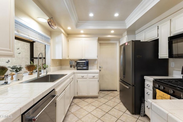 6613 Sargent Ln Unit 86, Ventura, CA 93003 - kitchen with black appliances, tile counters, crown molding, white cabinets, and recessed lighting