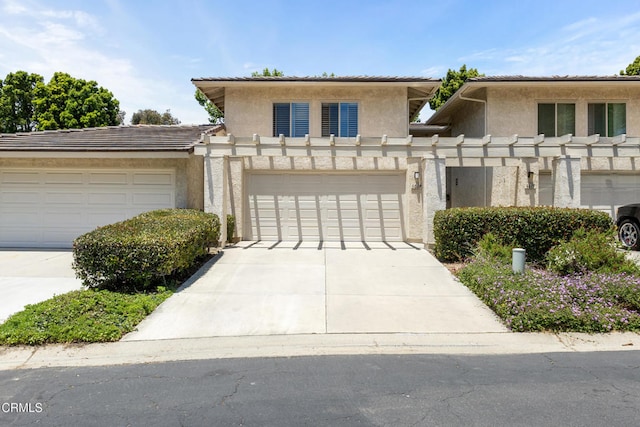 6613 Sargent Ln Unit 86, Ventura, CA 93003 - view of front of house featuring stucco siding, concrete driveway, a garage, and a tiled roof