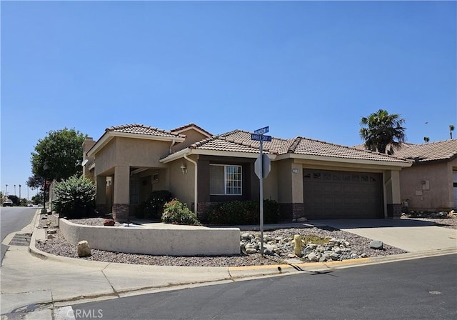 769 Amber Sky St, Banning, CA 92220 - mediterranean / spanish house with a garage, stucco siding, a tiled roof, and concrete driveway