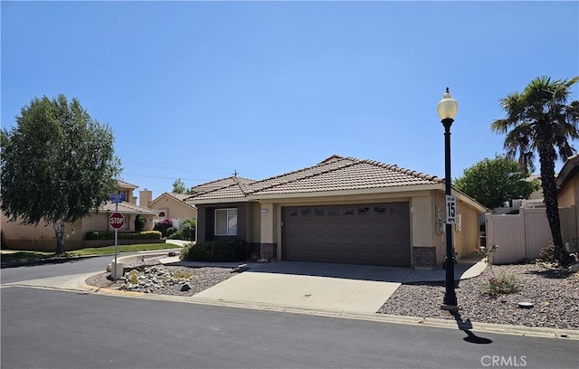 769 Amber Sky St, Banning, CA 92220 - view of front of house with a garage, stucco siding, concrete driveway, and a tiled roof