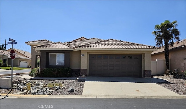 769 Amber Sky St, Banning, CA 92220 - view of front facade with an attached garage, concrete driveway, stucco siding, and brick siding