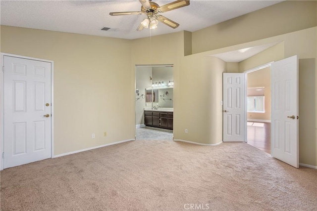 769 Amber Sky St, Banning, CA 92220 - unfurnished bedroom featuring carpet, ensuite bath, a textured ceiling, and a ceiling fan