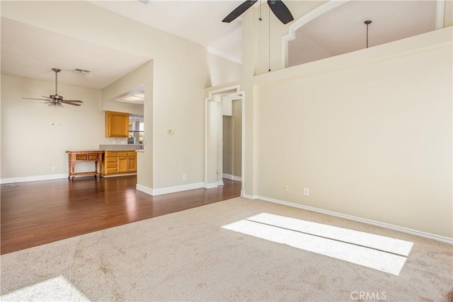 769 Amber Sky St, Banning, CA 92220 - unfurnished living room featuring ceiling fan, dark colored carpet, and dark wood-style flooring