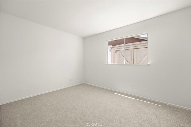 18312 Hartlund Ln, Huntington Beach, CA 92646 - carpeted spare room featuring baseboards