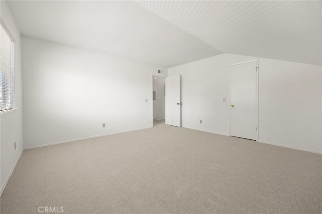 18312 Hartlund Ln, Huntington Beach, CA 92646 - unfurnished bedroom featuring light colored carpet and lofted ceiling
