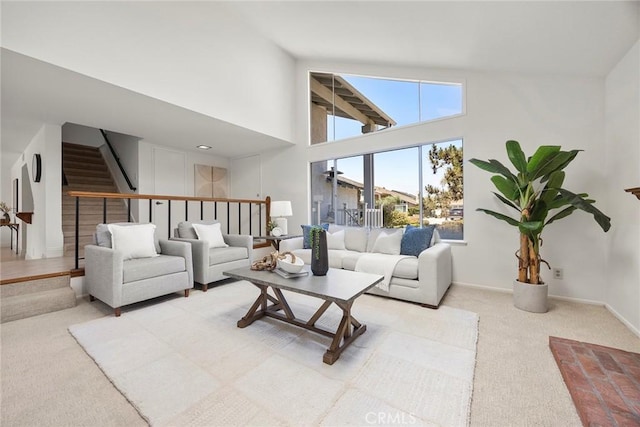 18312 Hartlund Ln, Huntington Beach, CA 92646 - carpeted living area featuring stairs and a towering ceiling