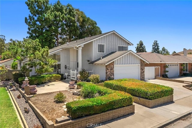 18312 Hartlund Ln, Huntington Beach, CA 92646 - view of front facade featuring a garage, driveway, board and batten siding, and roof with shingles