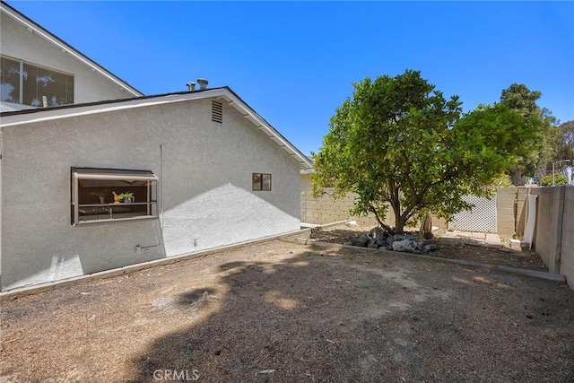 18312 Hartlund Ln, Huntington Beach, CA 92646 - view of side of home featuring stucco siding