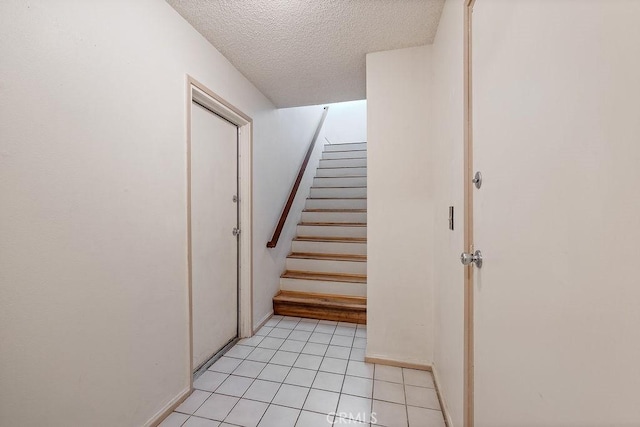 27066 Hidaway Ave Unit 6, Canyon Country, CA 91351 - staircase featuring a textured ceiling and tile patterned flooring