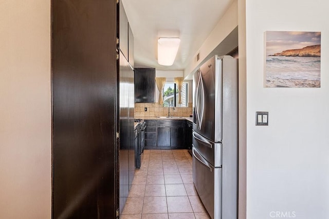 27066 Hidaway Ave Unit 6, Canyon Country, CA 91351 - kitchen featuring freestanding refrigerator, tasteful backsplash, light countertops, and light tile patterned floors