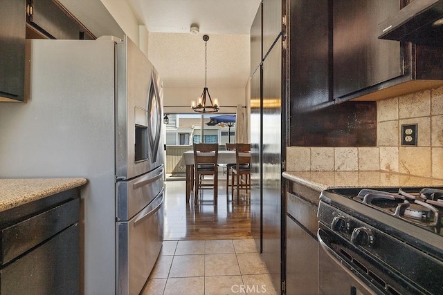 27066 Hidaway Ave Unit 6, Canyon Country, CA 91351 - kitchen featuring stainless steel refrigerator with ice dispenser, black range with gas stovetop, a chandelier, decorative backsplash, and light tile patterned flooring