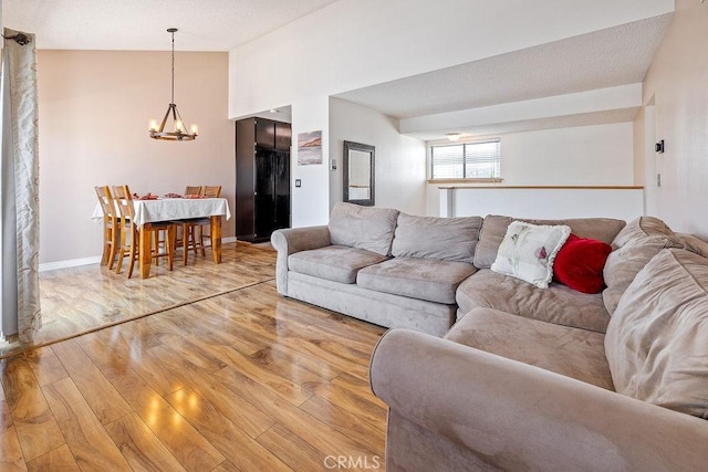 27066 Hidaway Ave Unit 6, Canyon Country, CA 91351 - living room featuring a chandelier, light wood-type flooring, and vaulted ceiling