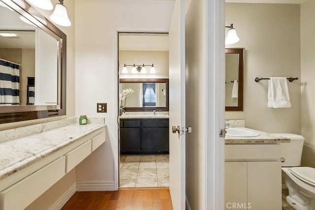 27066 Hidaway Ave Unit 6, Canyon Country, CA 91351 - bathroom featuring two vanities and wood finished floors