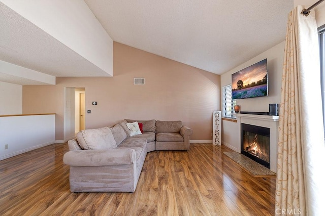27066 Hidaway Ave Unit 6, Canyon Country, CA 91351 - living area with lofted ceiling, wood finished floors, and a glass covered fireplace
