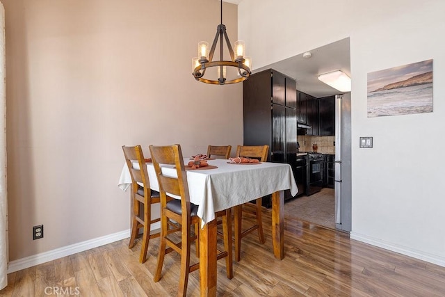 27066 Hidaway Ave Unit 6, Canyon Country, CA 91351 - dining area featuring a chandelier and light wood-style floors
