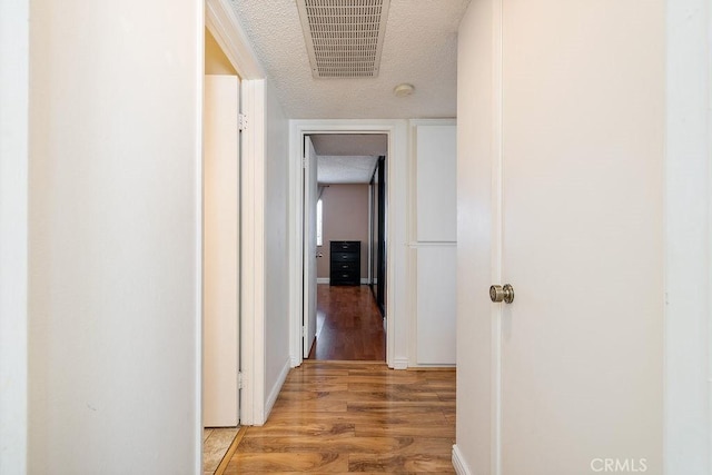 27066 Hidaway Ave Unit 6, Canyon Country, CA 91351 - corridor with a textured ceiling and wood finished floors