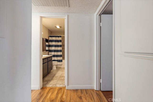 27066 Hidaway Ave Unit 6, Canyon Country, CA 91351 - hallway with light tile patterned floors and baseboards