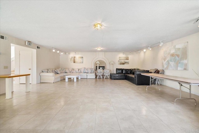 7394 Altiva Pl, Carlsbad, CA 92009 - living room with rail lighting, light tile patterned flooring, and a textured ceiling