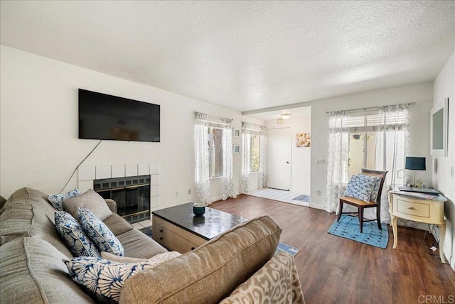7394 Altiva Pl, Carlsbad, CA 92009 - living room with wood finished floors, a tiled fireplace, and a textured ceiling
