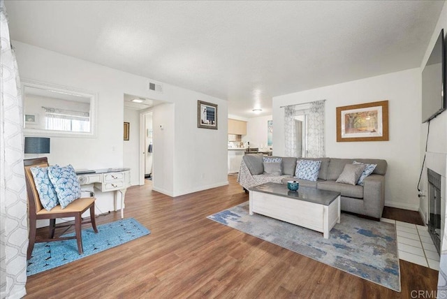 7394 Altiva Pl, Carlsbad, CA 92009 - living room featuring wood finished floors and baseboards