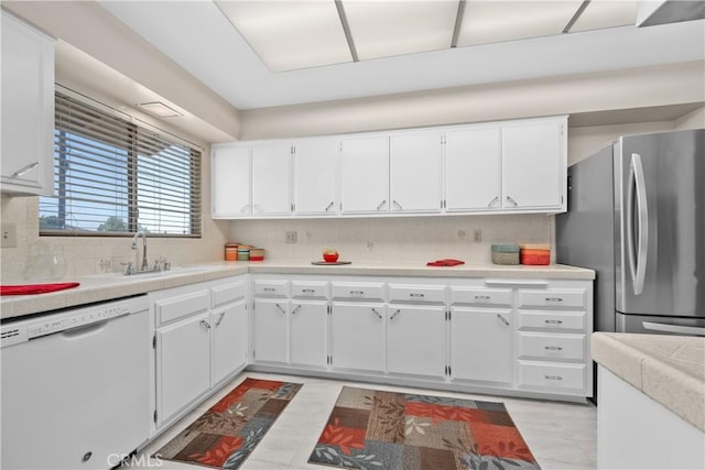 26480 Ridgemoor Rd, Menifee, CA 92586 - kitchen featuring dishwasher, freestanding refrigerator, white cabinets, decorative backsplash, and light countertops