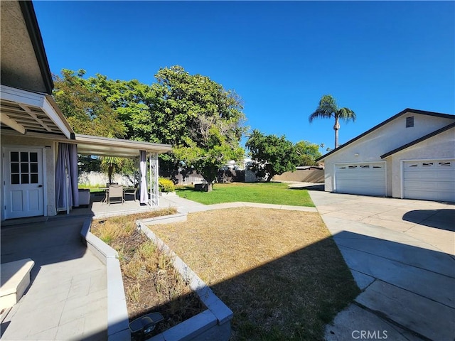 8420 E Hermosa Dr, San Gabriel, CA 91775 - view of yard featuring a garage, concrete driveway, and a patio