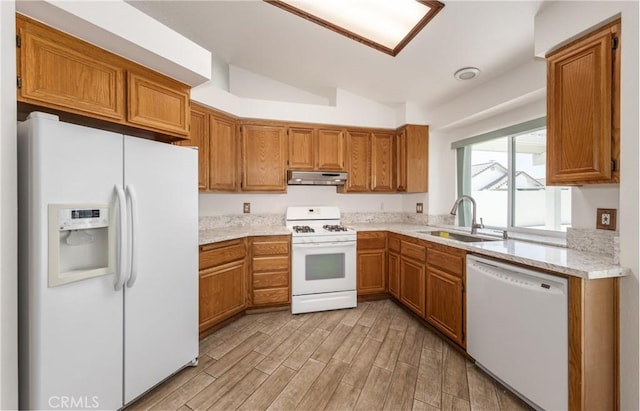655 Shasta Way, Beaumont, CA 92223 - kitchen with white appliances, under cabinet range hood, vaulted ceiling, and brown cabinets