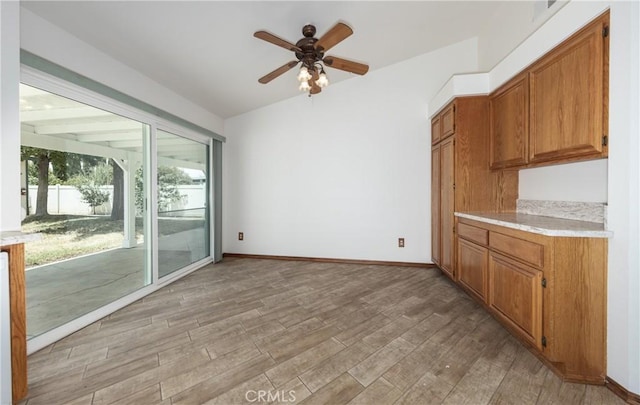 655 Shasta Way, Beaumont, CA 92223 - kitchen featuring light countertops, ceiling fan, light wood-style floors, and brown cabinets