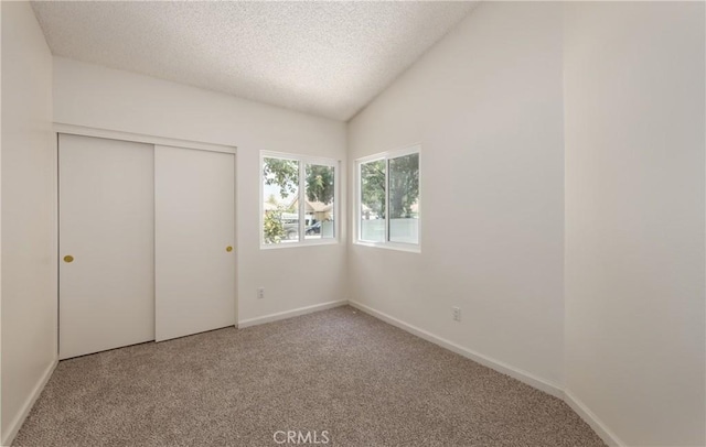 655 Shasta Way, Beaumont, CA 92223 - unfurnished bedroom featuring carpet flooring, a textured ceiling, a closet, and lofted ceiling