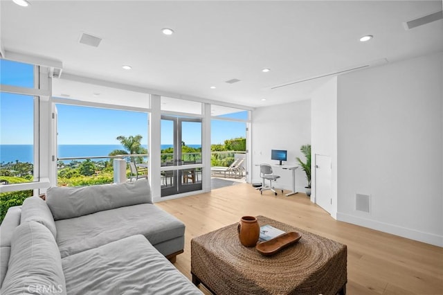 1061 Skyline Dr, Laguna Beach, CA 92651 - living area with floor to ceiling windows, light wood-style flooring, a water view, recessed lighting, and an office area