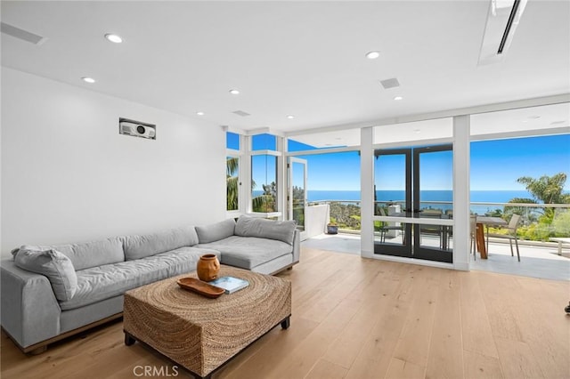 1061 Skyline Dr, Laguna Beach, CA 92651 - living area featuring floor to ceiling windows, light wood-type flooring, a water view, and recessed lighting