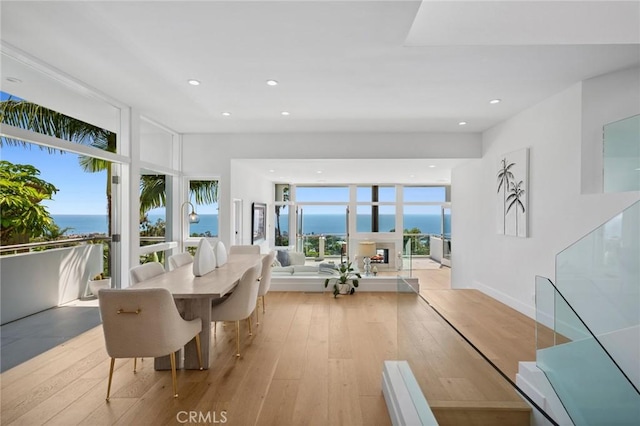 1061 Skyline Dr, Laguna Beach, CA 92651 - dining room with wood-type flooring, a water view, recessed lighting, and a wall of windows
