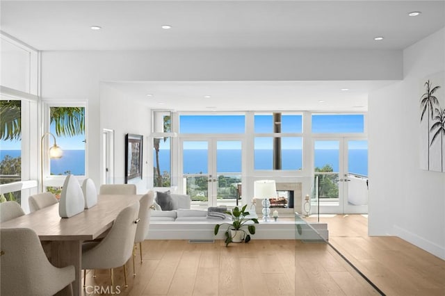 1061 Skyline Dr, Laguna Beach, CA 92651 - dining area with a premium fireplace, light wood finished floors, recessed lighting, and floor to ceiling windows
