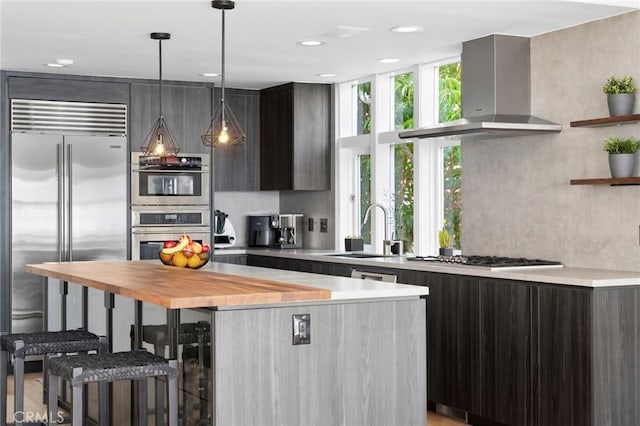 1061 Skyline Dr, Laguna Beach, CA 92651 - kitchen featuring wall chimney range hood, modern cabinets, stainless steel appliances, light countertops, and recessed lighting