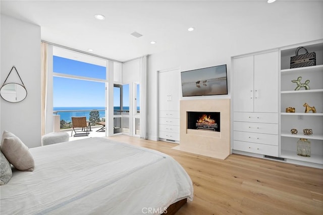 1061 Skyline Dr, Laguna Beach, CA 92651 - bedroom featuring a wall of windows, light wood-style floors, a fireplace with flush hearth, and recessed lighting