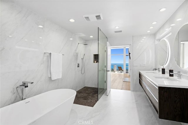 1061 Skyline Dr, Laguna Beach, CA 92651 - full bath with a soaking tub, a marble finish shower, double vanity, and recessed lighting