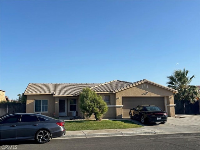 83785 Avenida Serena, Indio, CA 92203 - ranch-style house with stucco siding, a tile roof, concrete driveway, and a garage