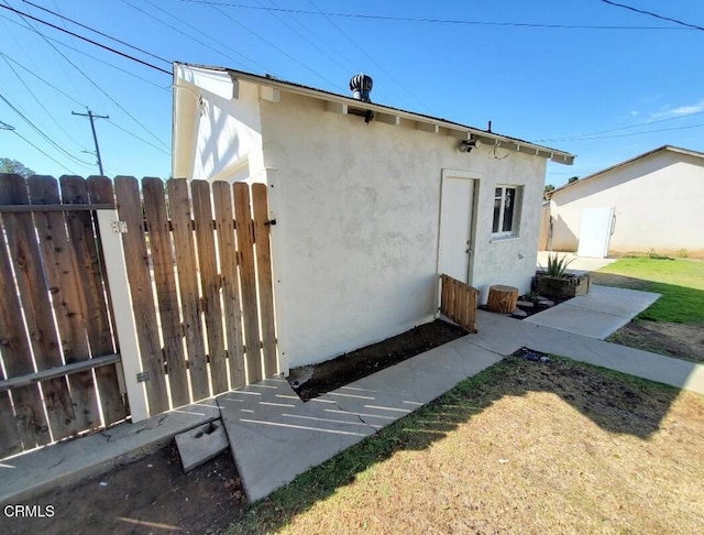 701 Francis St, Bakersfield, CA 93303 - rear view of house with stucco siding and a gate