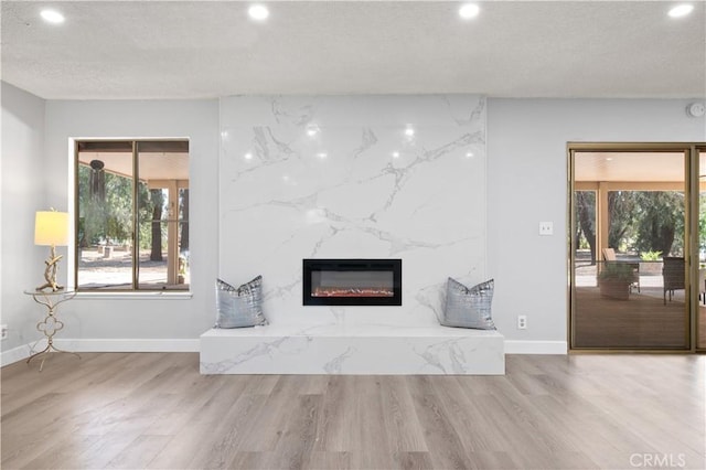 18561 Bert Rd, Riverside, CA 92508 - unfurnished living room featuring recessed lighting, a high end fireplace, wood finished floors, and plenty of natural light
