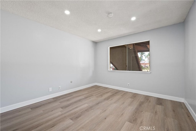 18561 Bert Rd, Riverside, CA 92508 - spare room featuring recessed lighting, wood finished floors, a textured ceiling, and a smoke detector