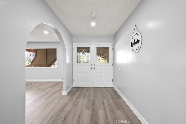 18561 Bert Rd, Riverside, CA 92508 - entrance foyer featuring arched walkways, wood finished floors, and a textured ceiling
