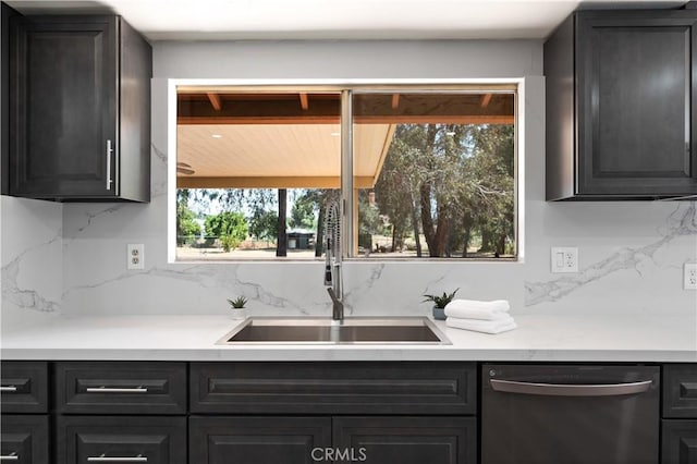 18561 Bert Rd, Riverside, CA 92508 - kitchen with dishwasher, tasteful backsplash, light countertops, and dark cabinets