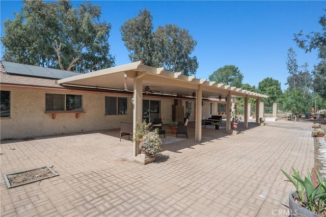 18561 Bert Rd, Riverside, CA 92508 - back of property with roof mounted solar panels, ceiling fan, stucco siding, a patio, and an outdoor hangout area