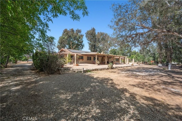 18561 Bert Rd, Riverside, CA 92508 - view of front of home with roof mounted solar panels and a patio area